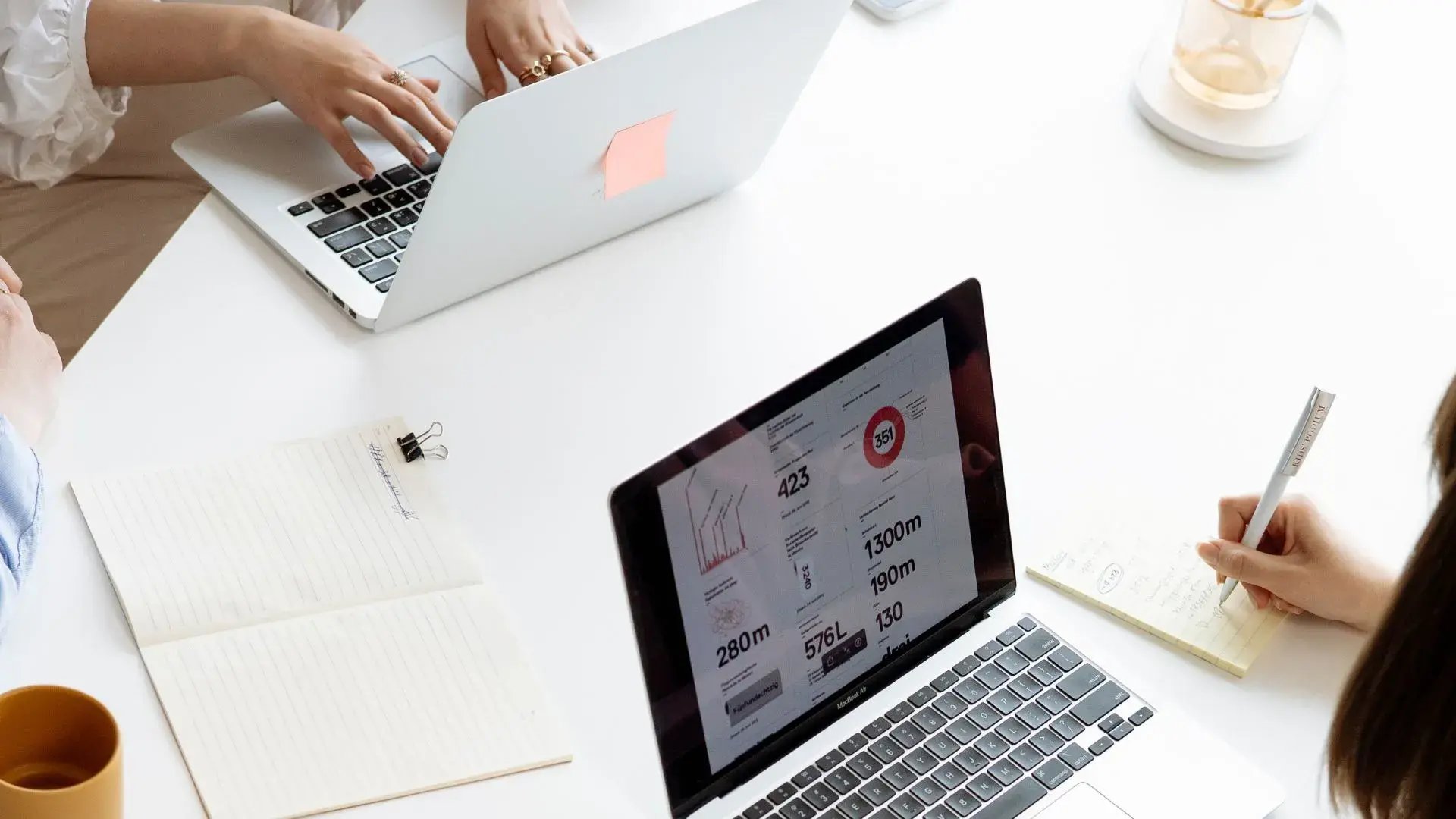 Two open laptops, with one showing a screen with statistical data&nbsp;